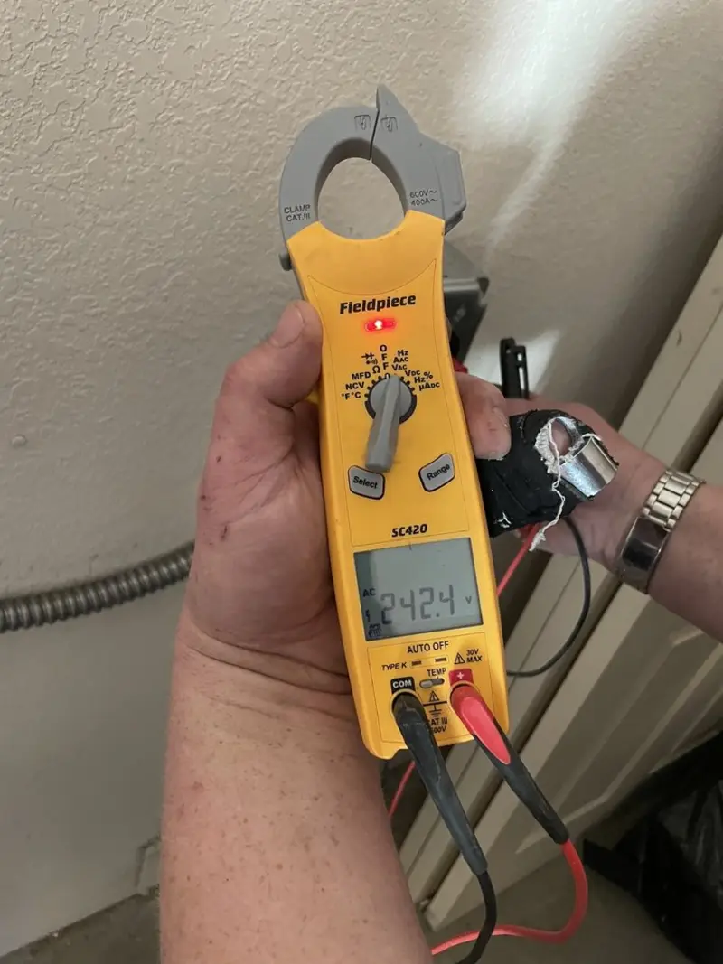 Voltage testing with clamp meter during Outlet Installation in Denton